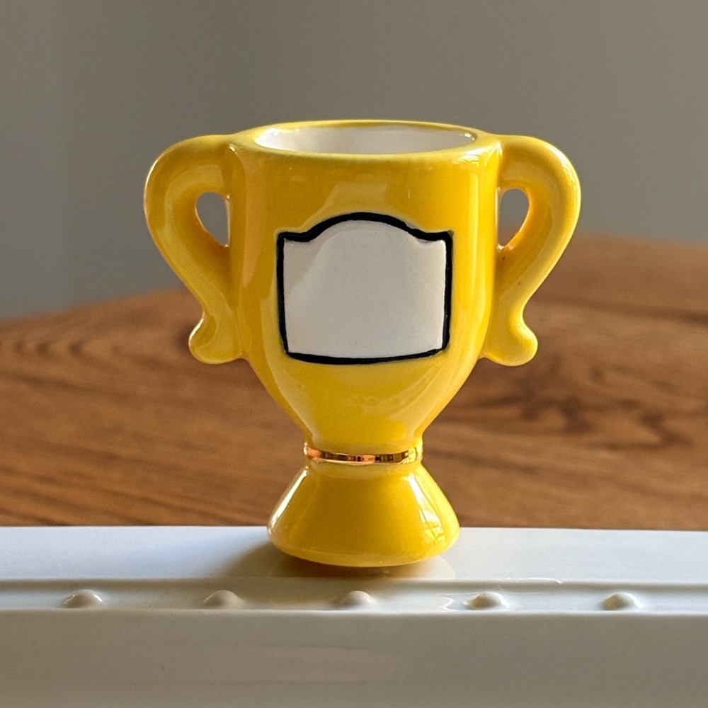 Nora Fleming Winner, Winner Yellow Ceramic Trophy-Shaped mini- Retired